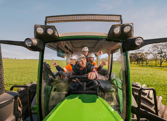 SA Power Networks people assist a tractor operator with farm safety. You Make the Network campaign image.