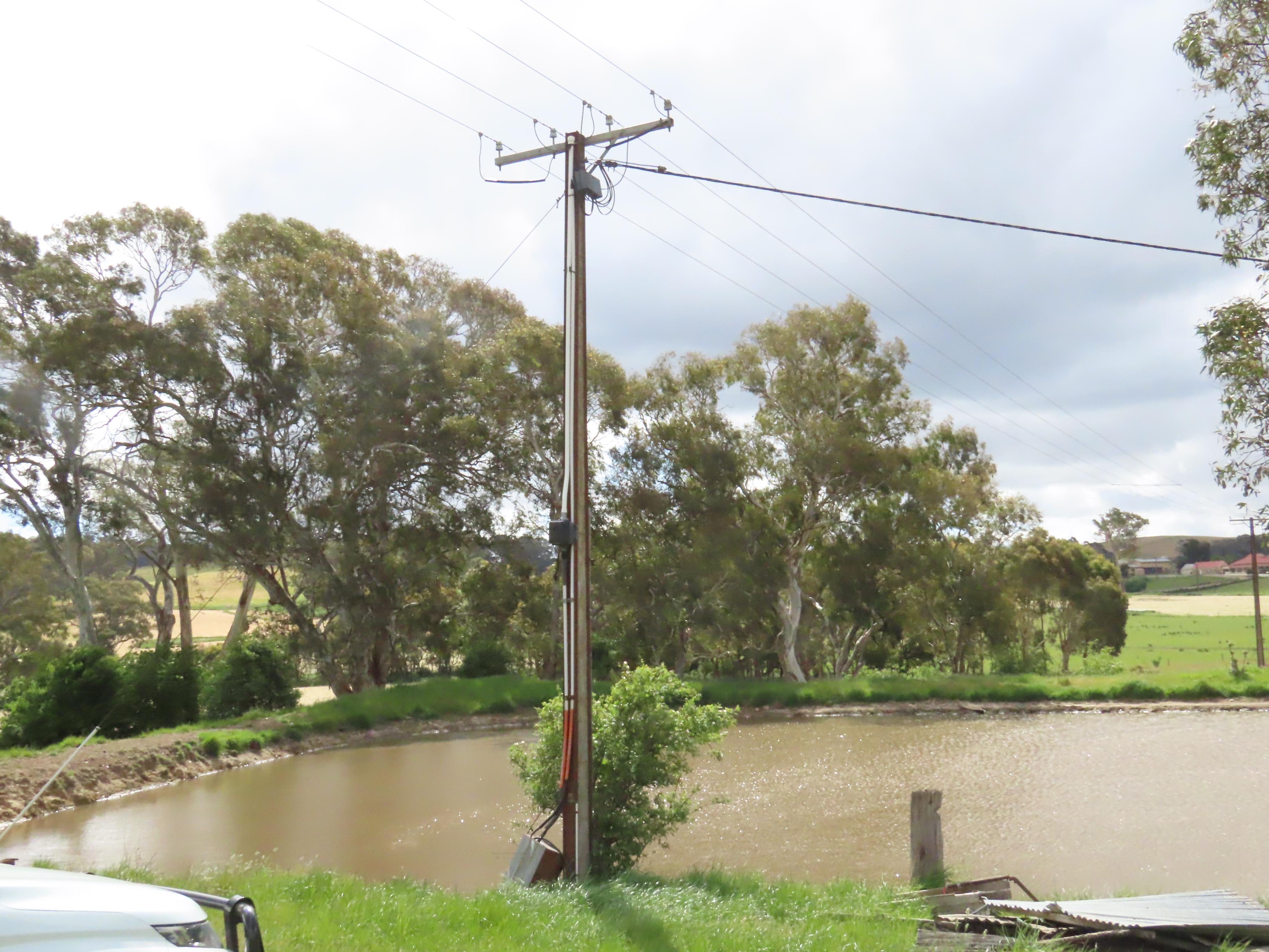 Privately-owned pole near pond damage